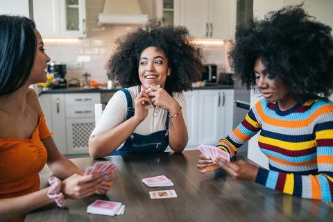 tri dievčatá doma hrajú karty